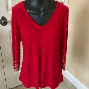 NWT. Dressy red top with rhinestone and pearl accented sleeves.